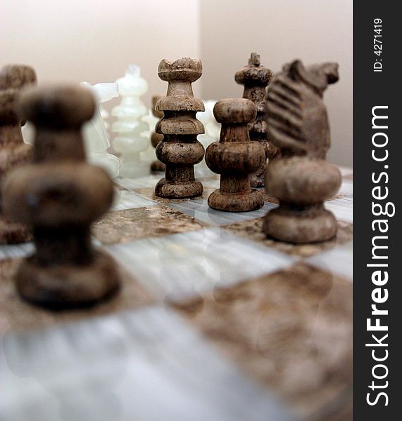 This is an image of several chess pieces arranged on a chess board. This is an image of several chess pieces arranged on a chess board.