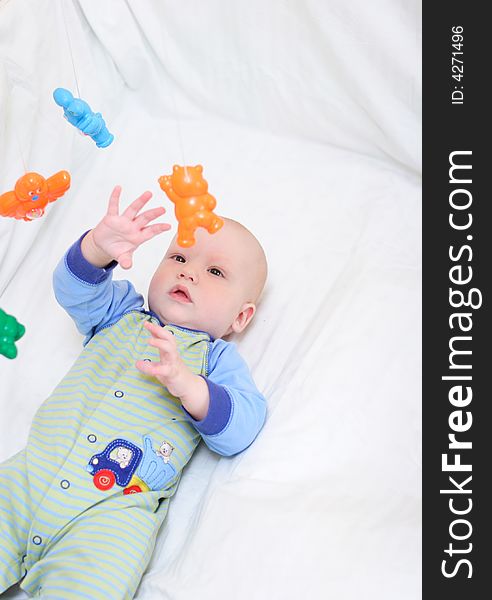 Baby playing with toys. Little boy touching the toys by finger