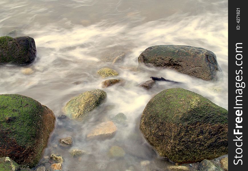 Water flowing over and around ocean rocks. Water flowing over and around ocean rocks.