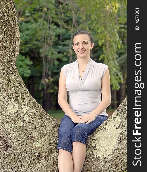 Girl sitting in a big tree. Girl sitting in a big tree