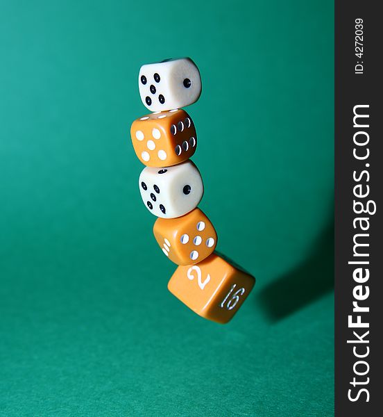 A stack of dice caught in mid-fall. A stack of dice caught in mid-fall