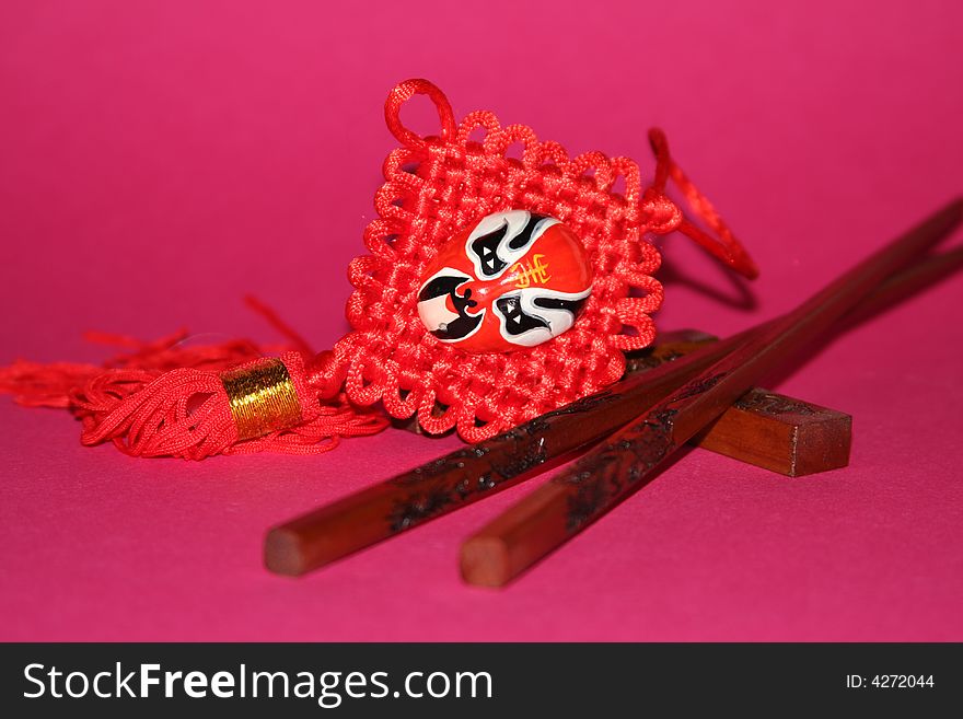 It is a Chinese traditional objects for food and decoration on a red background. It is a Chinese traditional objects for food and decoration on a red background