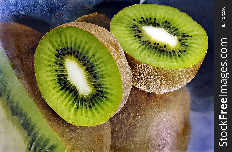 Kiwi sliced reflecting in a metal dish. Kiwi sliced reflecting in a metal dish