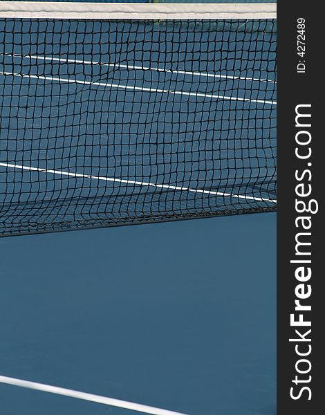 Tennis net on blue court