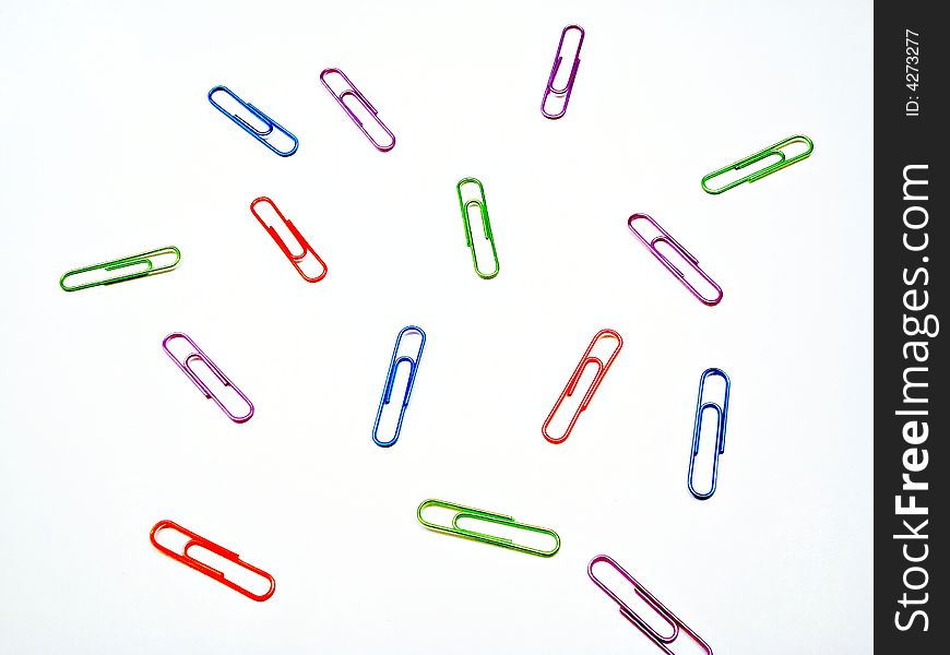 Scattered solored paper clips on white. Scattered solored paper clips on white.