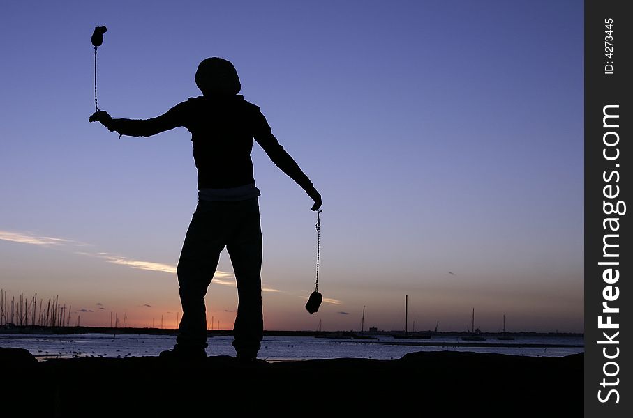 - playing poi against sunset - leisure time activity - St Kilda, Melbourne, Victoria, Australia. - playing poi against sunset - leisure time activity - St Kilda, Melbourne, Victoria, Australia