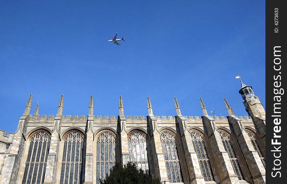Medieval Eton College Chapel in England against a clear blue Winter Sky with a plane flying overhead