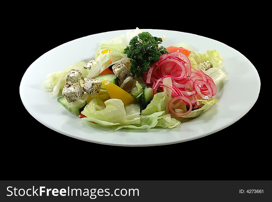 Salad with fresh lettuce leaves, tomato,feta, olives, pepper on a black background. Salad with fresh lettuce leaves, tomato,feta, olives, pepper on a black background.