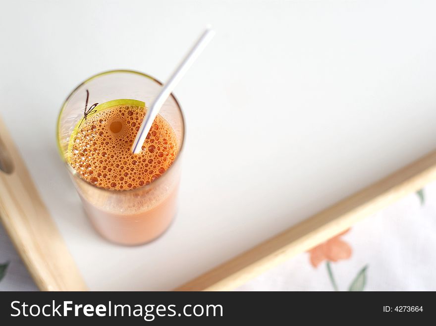 Carrots  fresh juice in a glass with sipper