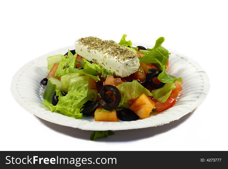 Salad with fresh lettuce leaves, tomato,feta, olives, pepper.