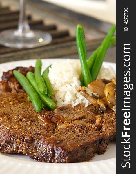 Cooked Ribeye meal rice green beans and mushrooms close up. Cooked Ribeye meal rice green beans and mushrooms close up