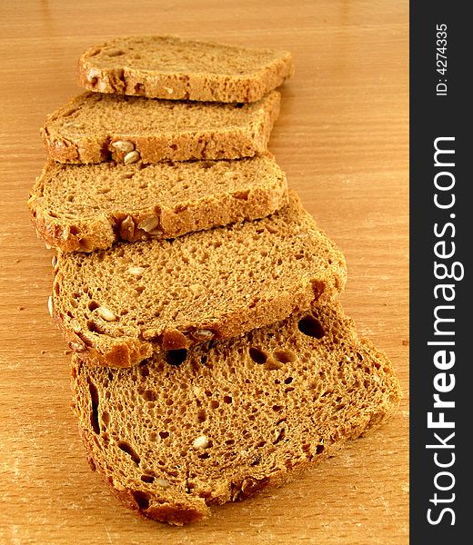Five slices of brown bread with whole crop grains. Five slices of brown bread with whole crop grains.