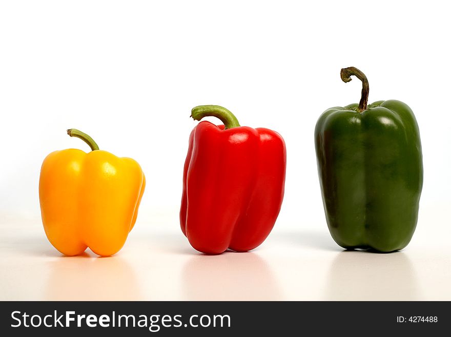 An image of color peppers in row