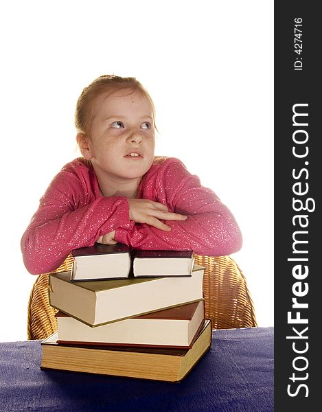 Young little girl above a stock of books