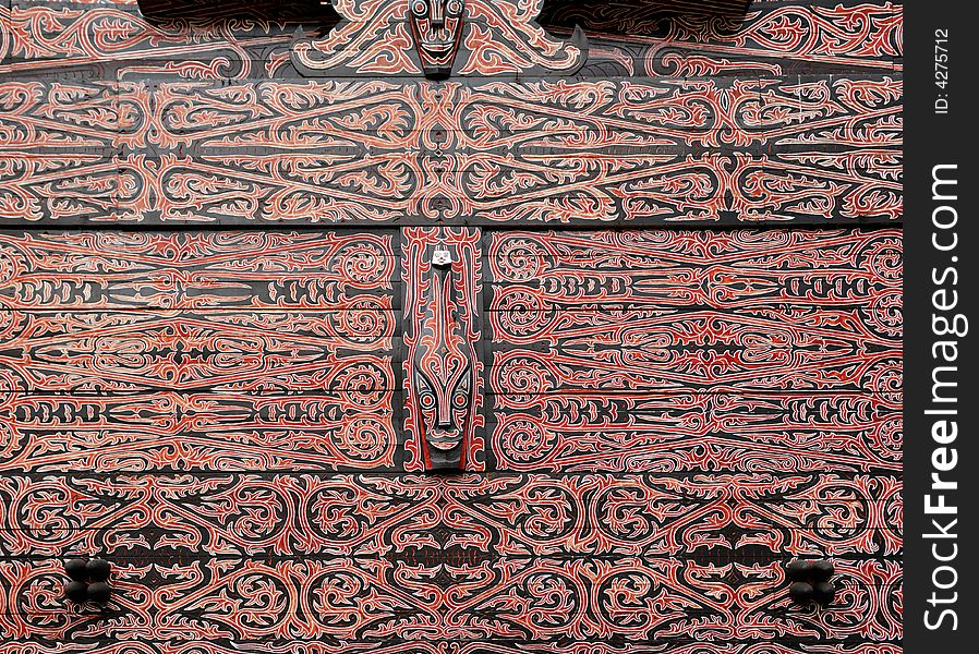 Indonesia, Sumatra:detail of a wood typical black and red painting and carved  decoration of an Indonesian house. Indonesia, Sumatra:detail of a wood typical black and red painting and carved  decoration of an Indonesian house