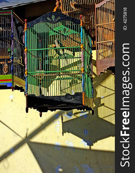 Indonesia, Java: sunny day at the market; bird cages and shades. Indonesia, Java: sunny day at the market; bird cages and shades