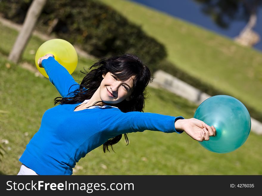 Beautiful teen handling balloons in the park. Beautiful teen handling balloons in the park