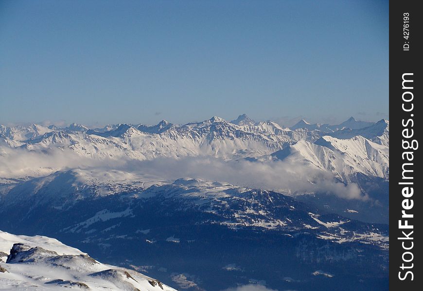 Fog in the valleys between many high peaks, eastern Switzerland.