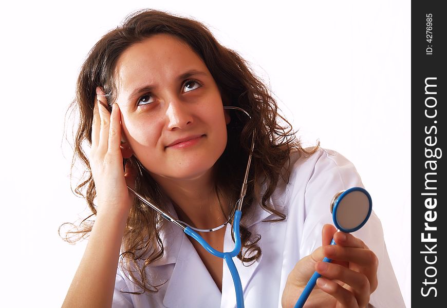 Female doctor using a stethoscope and smiling. Female doctor using a stethoscope and smiling