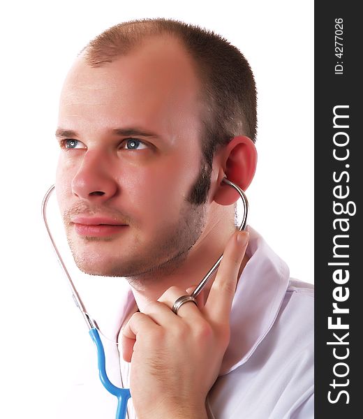 Young doctor using a stethoscope and smiling. Young doctor using a stethoscope and smiling