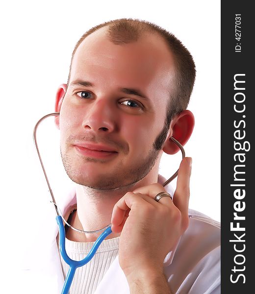 Young doctor using a stethoscope and smiling. Young doctor using a stethoscope and smiling