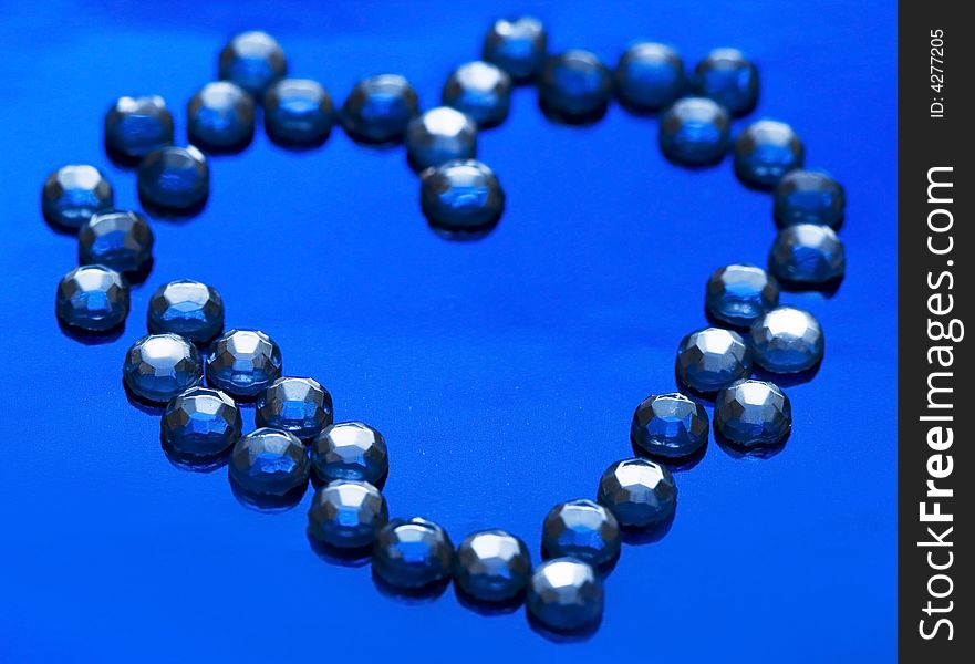 Heart from brilliant on blue background