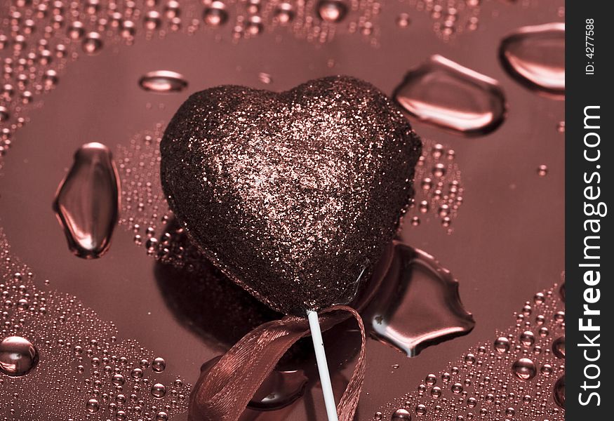 Holidays card, heart on background with water droplets