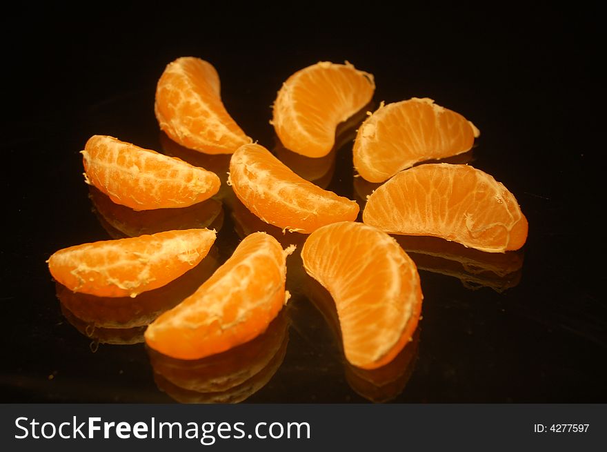A mandarin pieces on black table