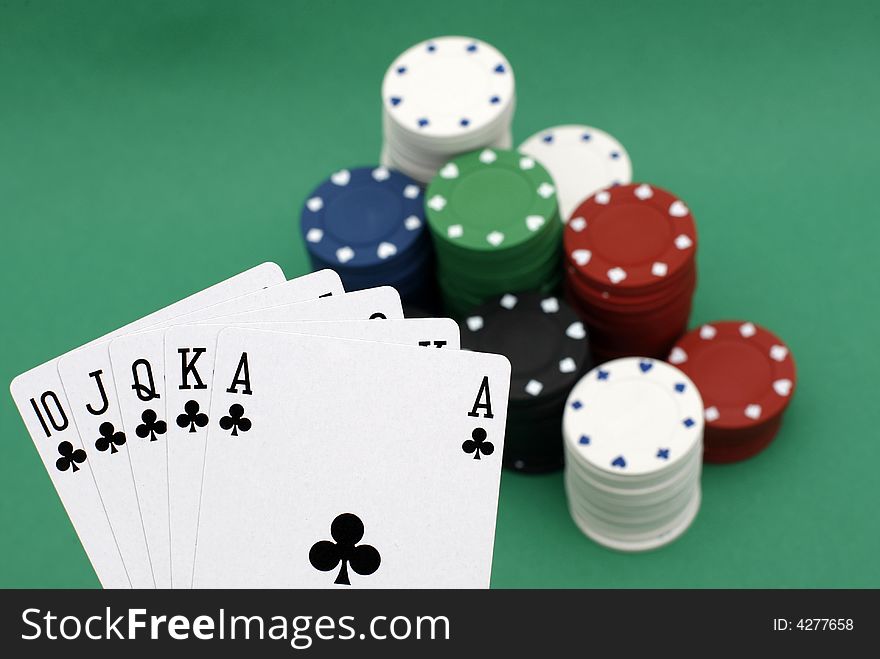 Poker playing cards royal flush with chips on green background. Poker playing cards royal flush with chips on green background