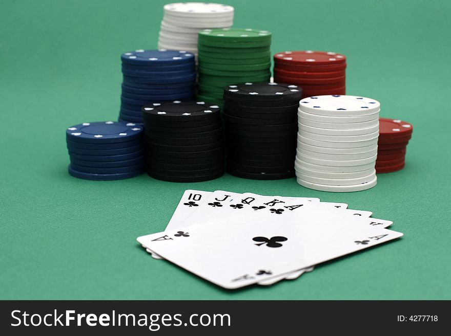 Poker playing cards royal flush with chips on green background