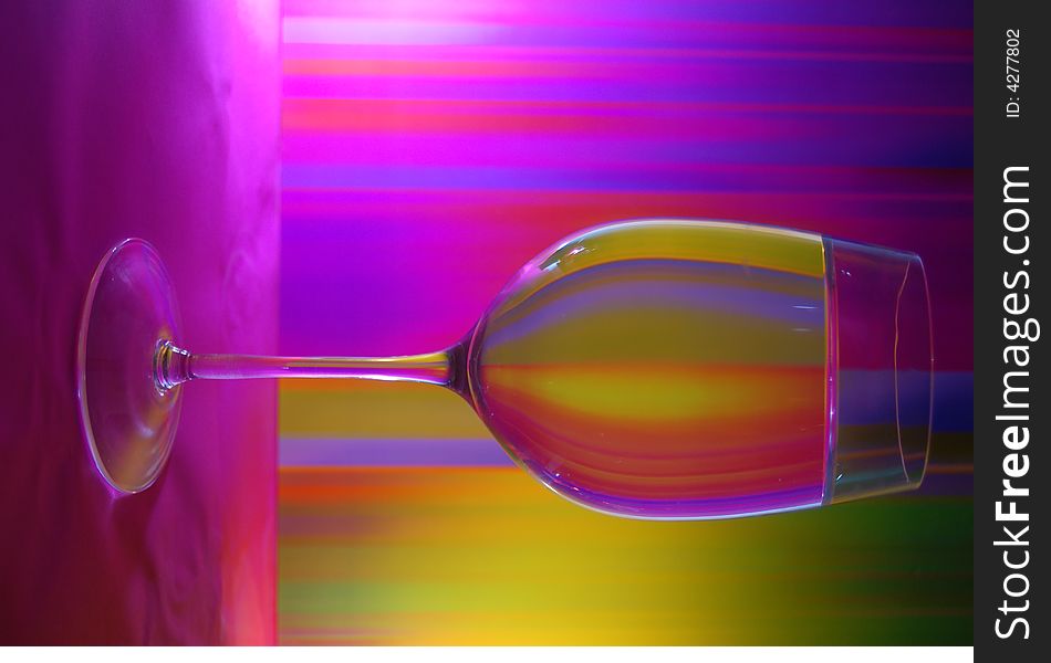 Glass of water on the background divided by colour