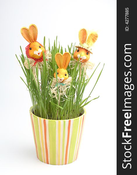 Easter rabbit family in a grass in colorful pot