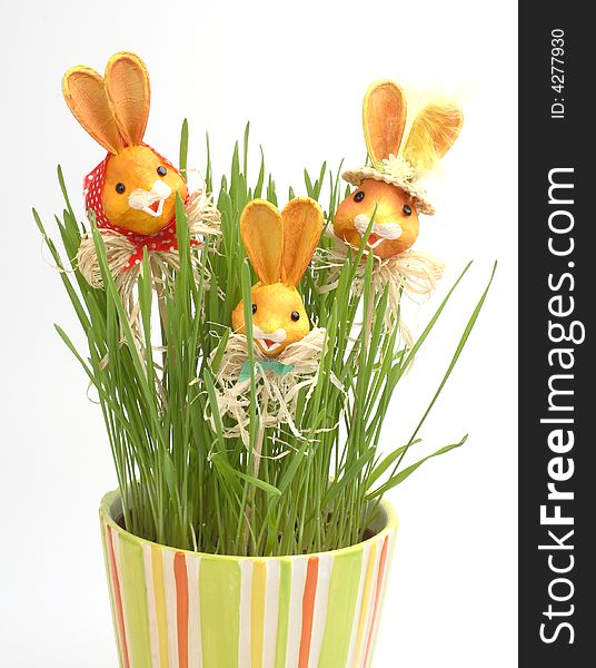 Easter rabbit family in a grass in colorful pot