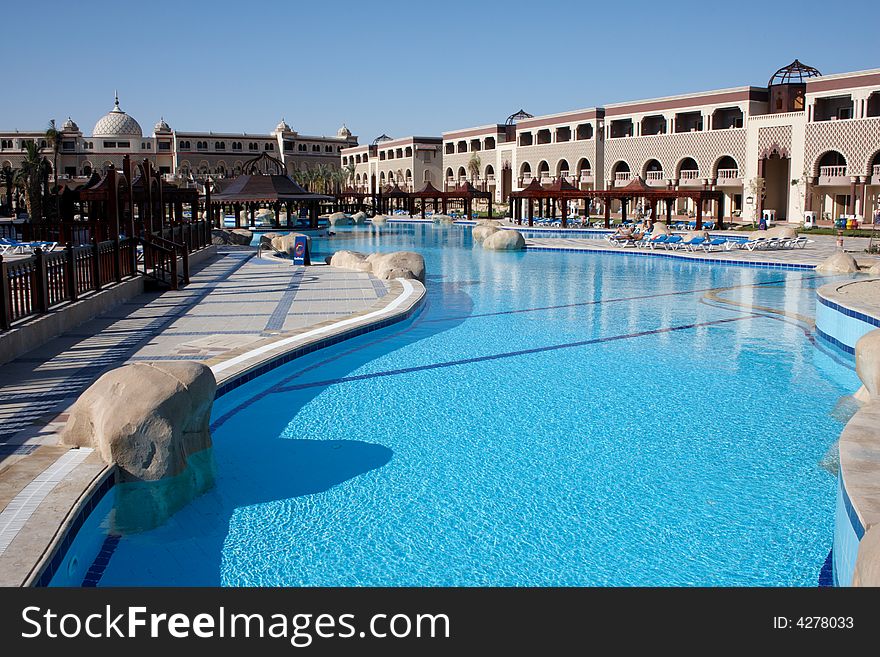 Swimming pool with bright blue water in oriental resort