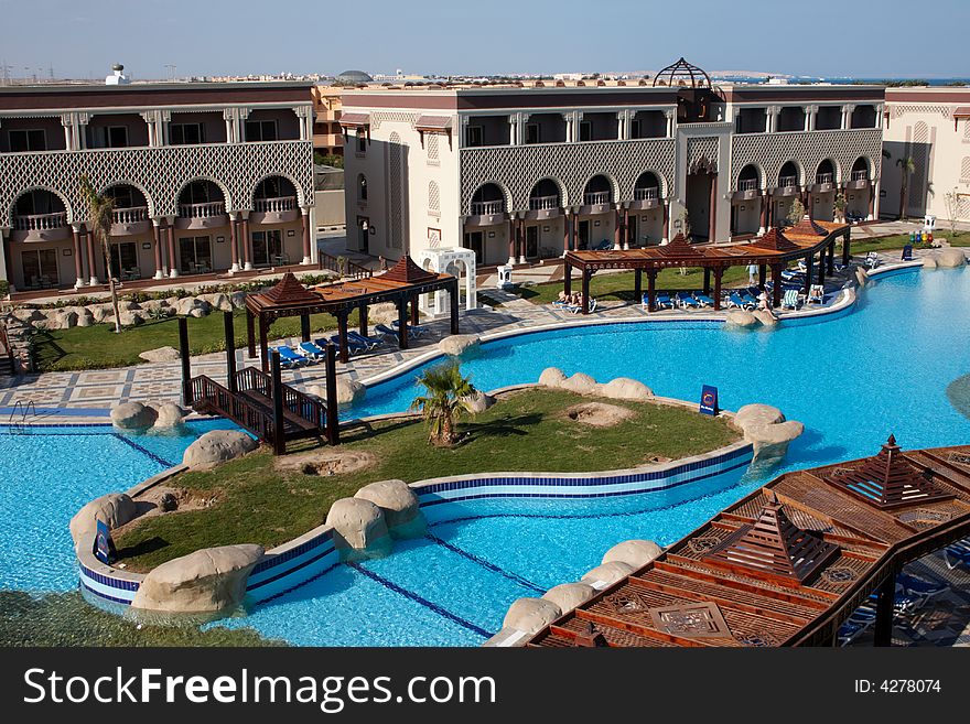 Oriental hotel with island and palm trees in swimming pool. Oriental hotel with island and palm trees in swimming pool