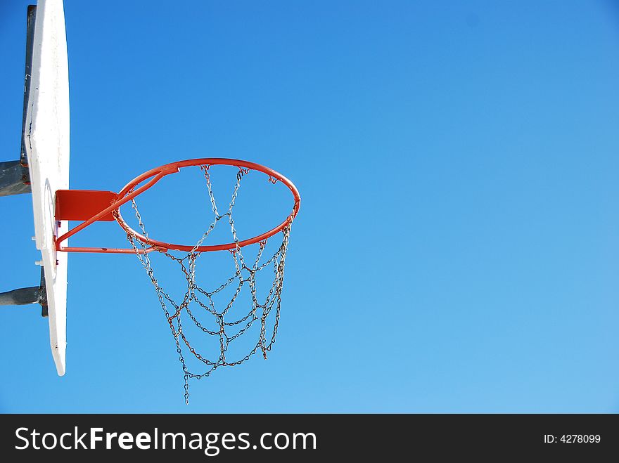Beautiful shot of a basket ball net agains the blue sky