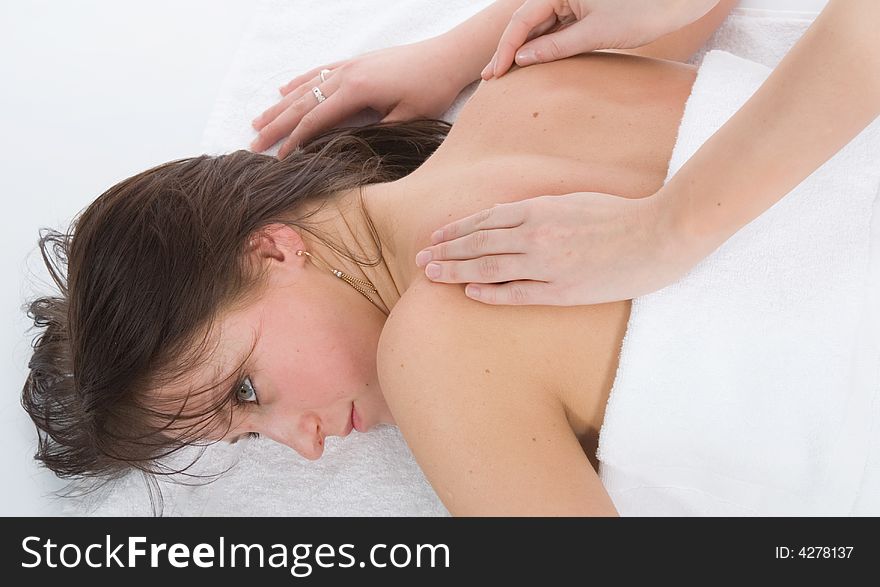 Pampered young woman with male hands doing a massage. Pampered young woman with male hands doing a massage