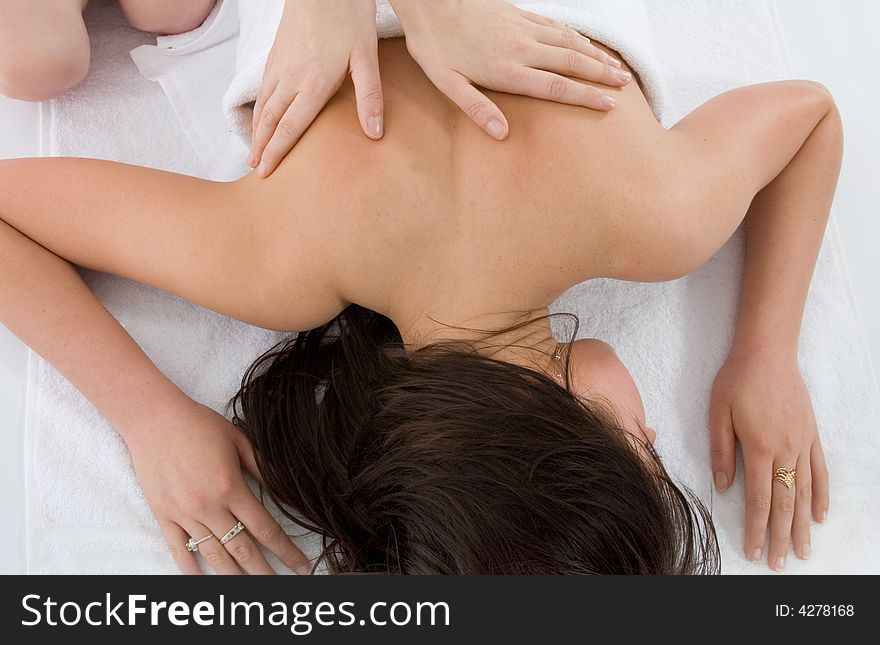 Pampered young woman with male hands doing a massage. Pampered young woman with male hands doing a massage