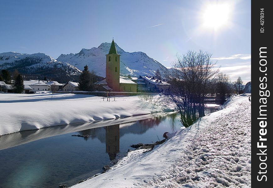 Small church on the banks of a river snow (Switzerland). Small church on the banks of a river snow (Switzerland)