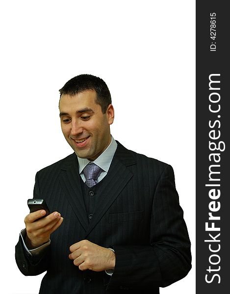 A man, holding a cellular phone in his hands, wearing a suit, looking happy. A man, holding a cellular phone in his hands, wearing a suit, looking happy