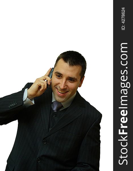 A man, holding a cellular phone in his hands, looking very happy while talking. A man, holding a cellular phone in his hands, looking very happy while talking
