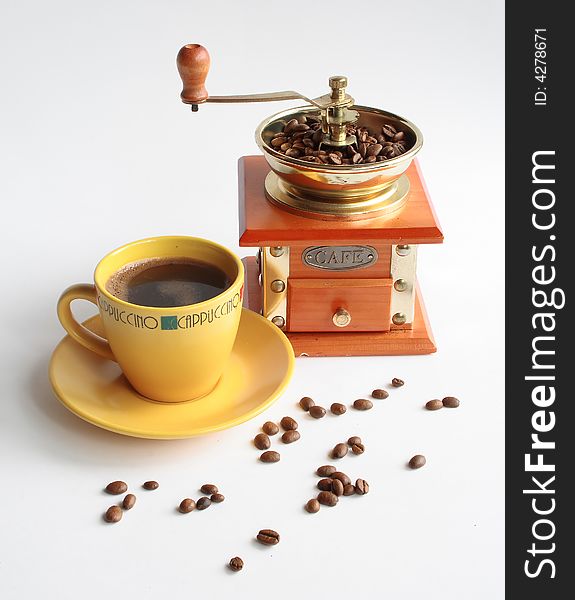 Coffee mill cup of coffee and coffee grain