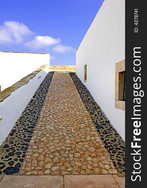 Portugal, area of Algarve, Lagos: typical military architecture. small white and black stones pavement for this typical portuguese fortress