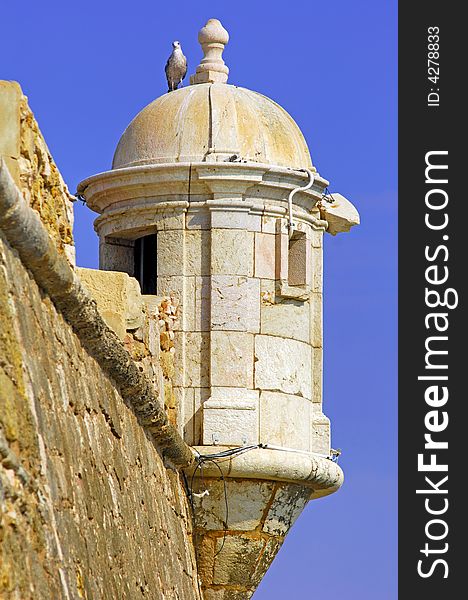 Portugal, area of Algarve, Lagos: typical military architecture, Fortress; white crow's nest with seagull on the domes top. Portugal, area of Algarve, Lagos: typical military architecture, Fortress; white crow's nest with seagull on the domes top