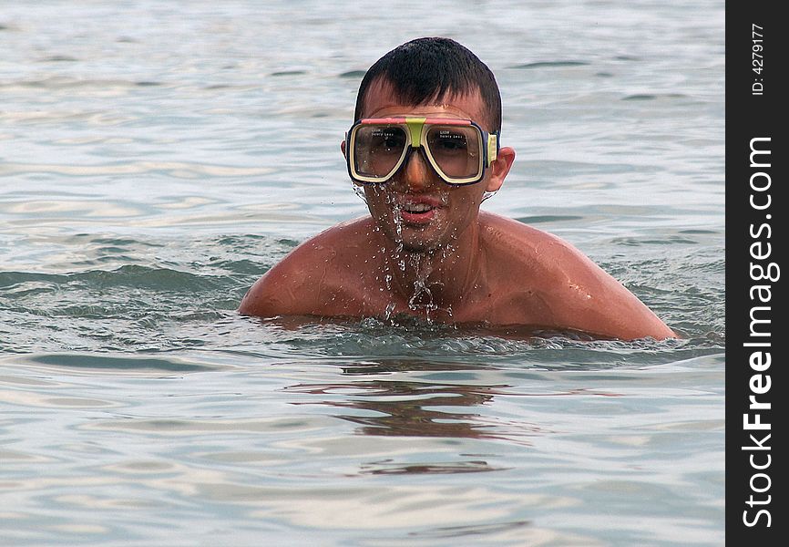 Young boy swiming in the sea