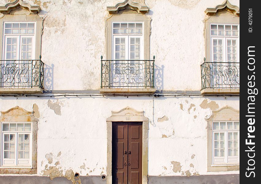 Portugal, area of Algarve, Tavira: detail of a solar or noble house;Typical architecture in white with framed windows and green iron balconies. Portugal, area of Algarve, Tavira: detail of a solar or noble house;Typical architecture in white with framed windows and green iron balconies