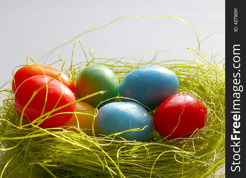 Colorful small Easter eggs in nest