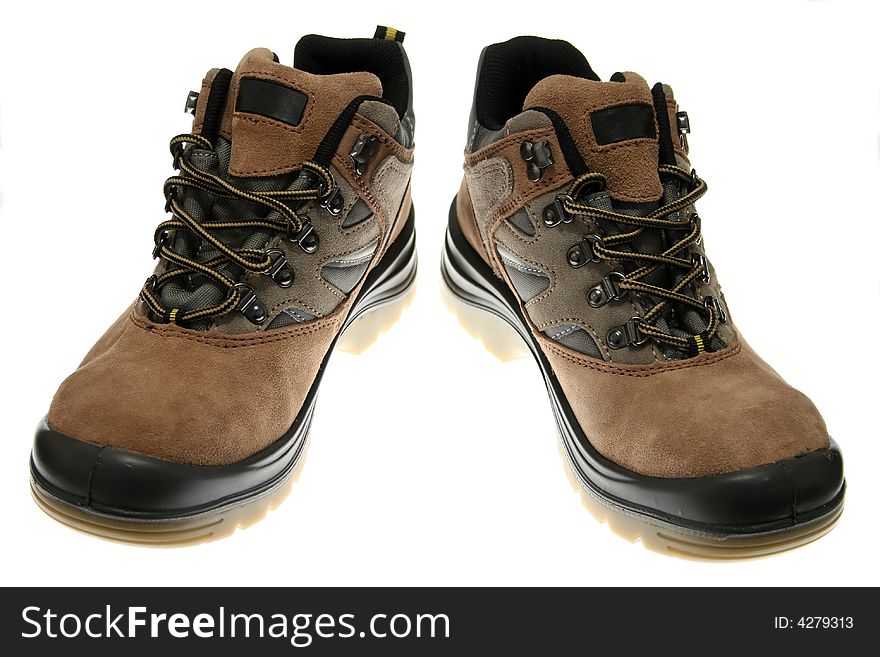 Brown leather workmans boots against white background.