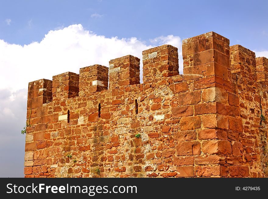 Portugal, Algarve, Silves: blue sky and detail of the main tower of the red stone castle. Portugal, Algarve, Silves: blue sky and detail of the main tower of the red stone castle