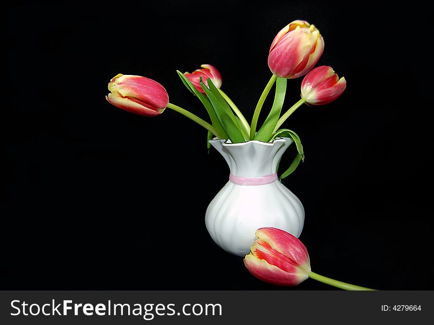 Bouquet of spring tulips in an old vase. Bouquet of spring tulips in an old vase.